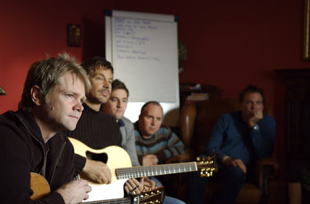 Compassionart songwriters craft a song in one of the writers rooms at the House of Cantle in Scotland. Pictured (l-r) are:  Steven Curtis Chapman, Paul Baloche, Tim Hughes, Jim McNeish (House of Cantle owner) and Mark Zchech (husband of Darlene).